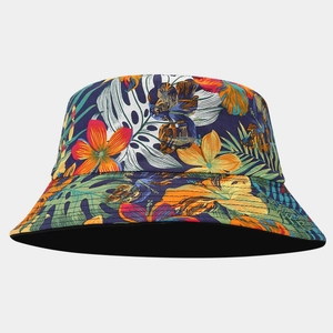 Detail showing tropical floral pattern with palm leaves on a navy reversible bucket hat