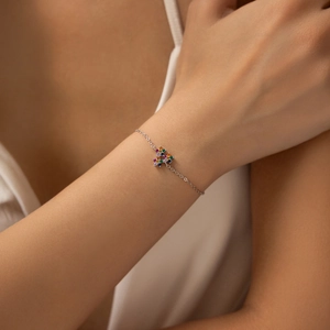 Elegant S925 sterling silver bracelet featuring colorful gemstone flowers on a model's wrist