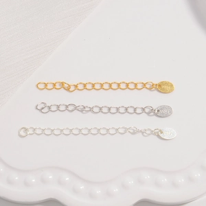 Macro detail of S925 sterling silver extension chains in gold, silver and platinum tones