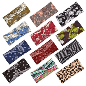 Collection of twelve elastic sports headbands featuring floral and paisley print patterns