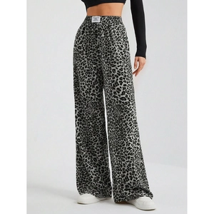 Detail view of high-waist leopard print wide-leg trousers with elegant drape effect