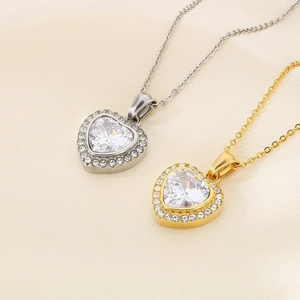 Detail of heart-shaped diamond pendants in gold and silver finishes with crystal center