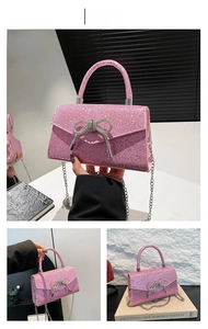 Detail of pink sequin crossbody bag featuring a sparkling silver rhinestone butterfly bow