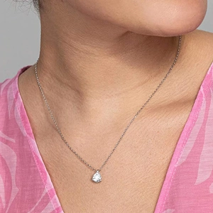 Elegant pear-shaped zircon pendant necklace with a fine silver-tone chain on a female model
