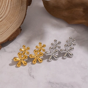 Close-up of elegant double-layered flower stud earrings in polished gold and silver finishes