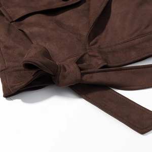 Detailed close-up of brown suede jacket showing waist tie-up knot and fabric texture