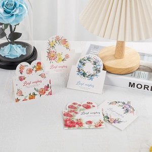 Detailed view of 5 watercolor floral heart cards with Best Wishes text in cozy setting