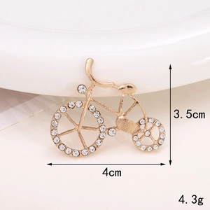 Detail showing dimensions and weight of a gold bicycle brooch with white rhinestones