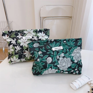 Detail of floral jacquard makeup bags with simple wish labels and zipper closure