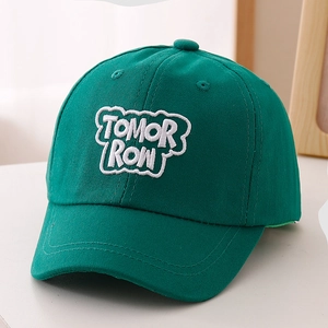 Detailed view of dark green baseball cap with white 3D TOMORROW embroidery