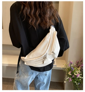 Rear view of cream PU leather crossbody chest bag on model with wide shoulder straps