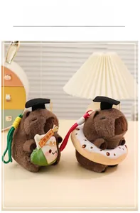 Capybara plush keychain with graduation cap, donut, and lucky zongzi charms
