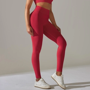 Detail view of red seamless high waist yoga pants showing compression and lifting effect