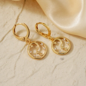 Elegant gold celestial dangle earrings featuring hollow circle with moon star and zircon stones