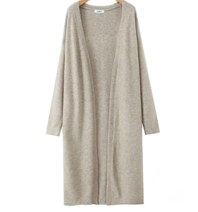 Detail of long beige knitted cardigan featuring soft textured fabric and an open-front design