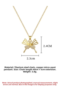Detail of gold butterfly pendant with cubic zirconia inlay and titanium steel O-chain