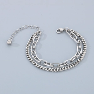 Detail of silver stainless steel double-layered bracelet with Cuban and oval links