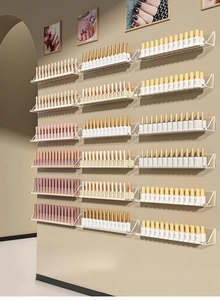 Macro view of clear acrylic wall-mounted nail polish racks with a U-shaped design