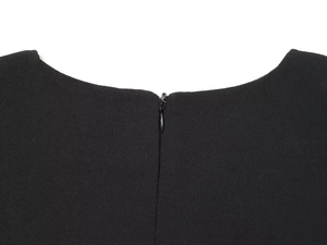 Detail of the back neckline on a black dress featuring a seamless invisible zipper closure