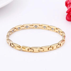 Minimalist gold titanium steel therapy bracelet with magnetic stones in closed loop view
