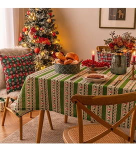 Detailed Christmas tablecloth with reindeer and snowflake patterns on a festive dining table