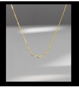 Macro detail of gold-plated S925 silver smile necklace with sparkling zircon stars