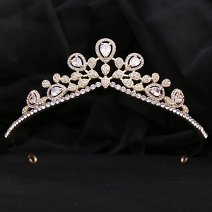 Elegant gold bridal crown featuring pear-cut white crystals and symmetrical royal patterns