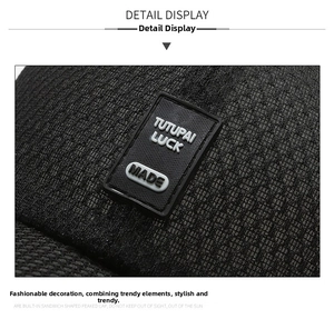 Detailed macro view of the mesh fabric texture and Tutupai Luck rubber patch on a black cap