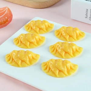 Set of six realistic yellow dumpling food models showing intricate texture and folds