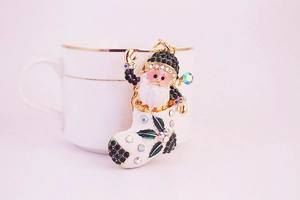 Close-up of sparkling rhinestone Santa boot keychain with gold-plated holiday details