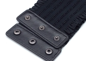 Detailed close-up of the black faux leather snap button closure on a wide lace-edge belt