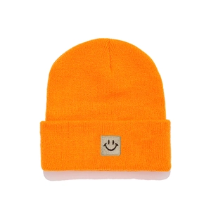 Vibrant orange ribbed knit beanie for kids with a gray square smiley face patch