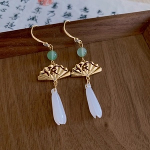 Golden fan earrings with green beads and white flower charms on vintage paper
