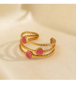 Detail of gold triple-layered wave ring with three pink enamel round accents