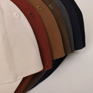 Close-up of premium twill cotton baseball caps showing embroidered eyelets and stitching