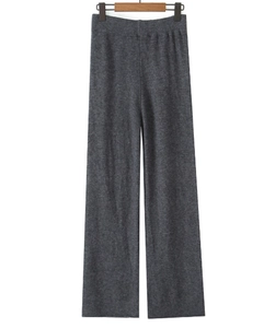 Detail of dark grey knit wide-leg pants with high elastic waist on wooden hanger