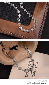 Detailed macro view of vintage silver daisy flower necklace with textured metal petals
