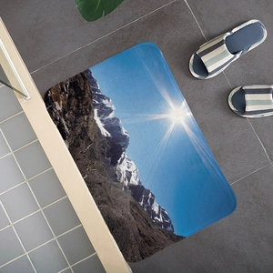 Absorbent flannel floor mat with snow mountain landscape print and non-slip backing