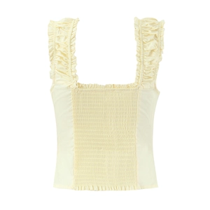 Detail of cream sleeveless top with smocked bodice and ruffled shoulder straps on white background