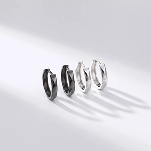 Detail view of geometric S925 sterling silver hoop earrings in black and silver finishes