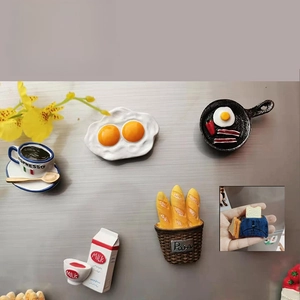 Macro detail of 3D resin breakfast fridge magnets featuring realistic food miniatures