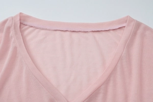Close-up of V-neck stitching and fine knit texture on a pink summer long sleeve top