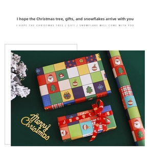 Detailed view of Christmas gift wrapping paper with festive plaid patterns and Santa icons