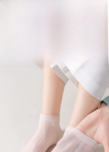 Close-up of light pink mulberry silk mesh socks with breathable honeycomb texture