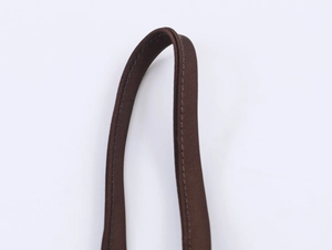 Close-up of dark brown woven shoulder strap with high-density fabric and neat stitching