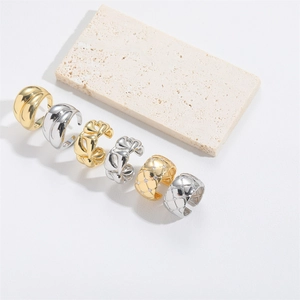 Detailed view of adjustable gold and silver rings with woven and quilted patterns