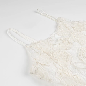 Detail of white 3D floral applique on lace camisole showing texture and petal layers