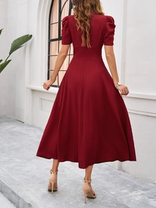Elegant back view of wine red midi dress with puff sleeves and pleated skirt details