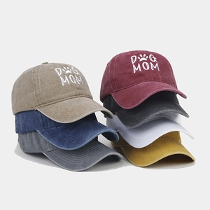Multiple colors of washed cotton baseball caps with Dog Mom embroidery and paw print