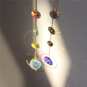 Close-up of golden suncatcher crystal sphere casting vibrant rainbow light reflections